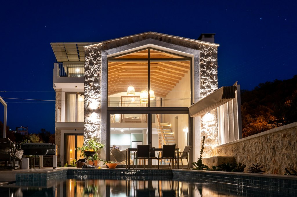 Pool villa lit up at night
